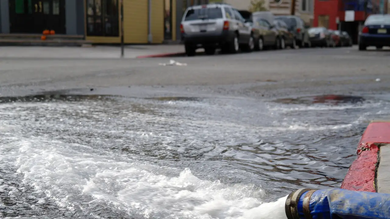 Water being pumped out of a building into the street