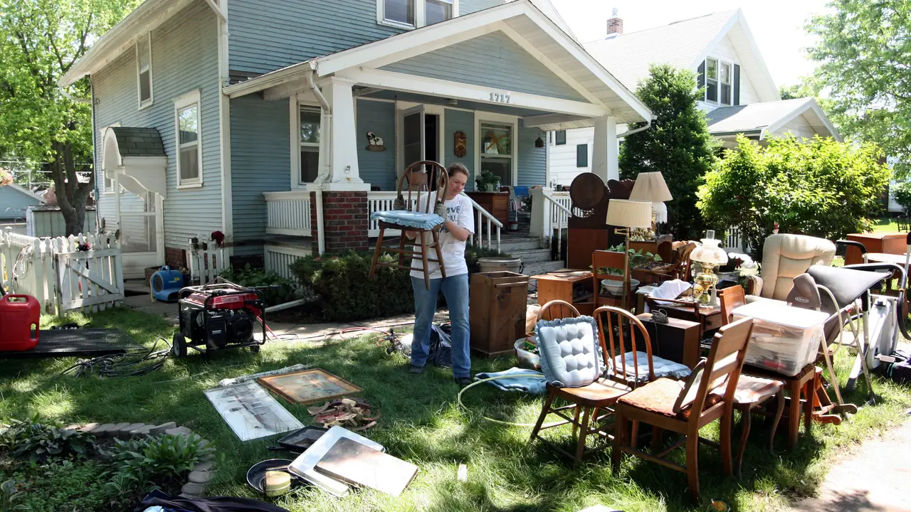 Flood-damaged furniture set out to dry on a front lawn
