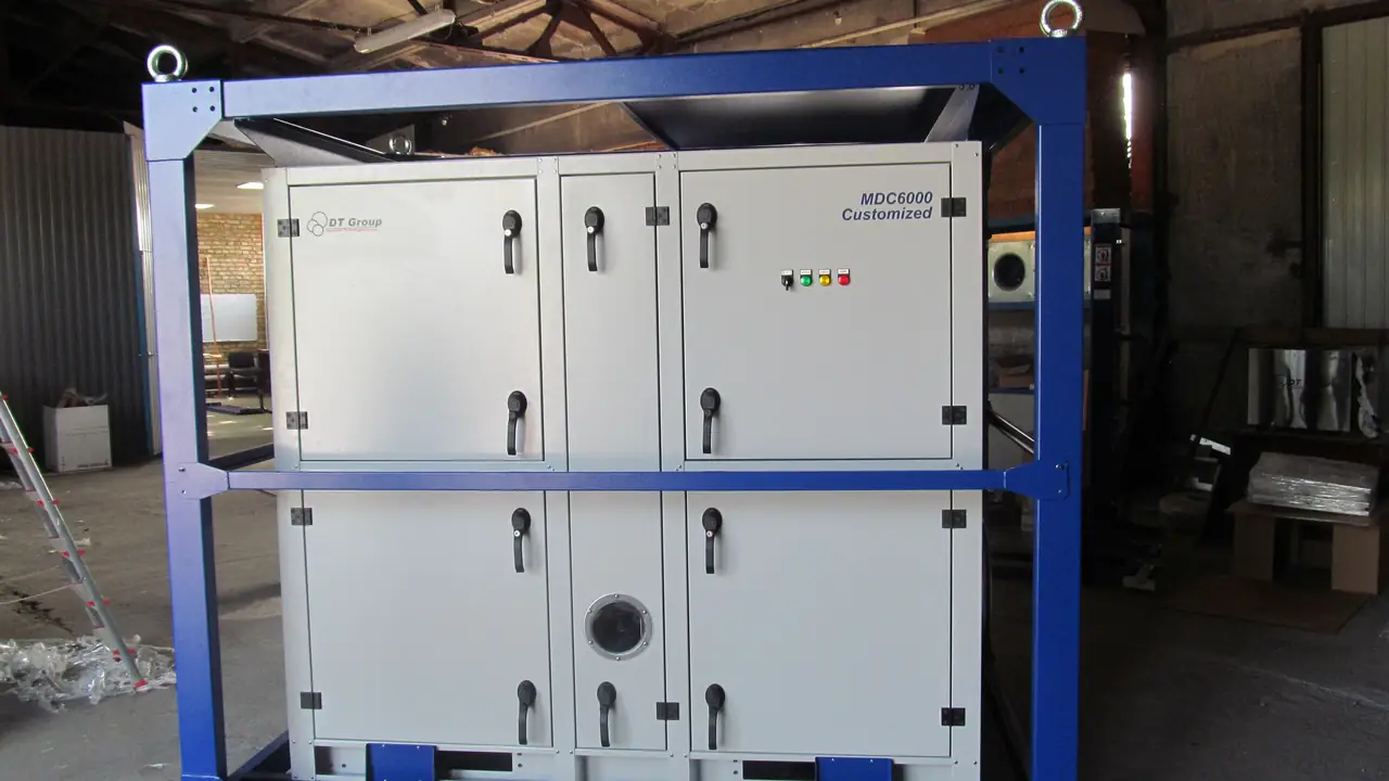 Commercial dehumidifier drying a water-damaged room