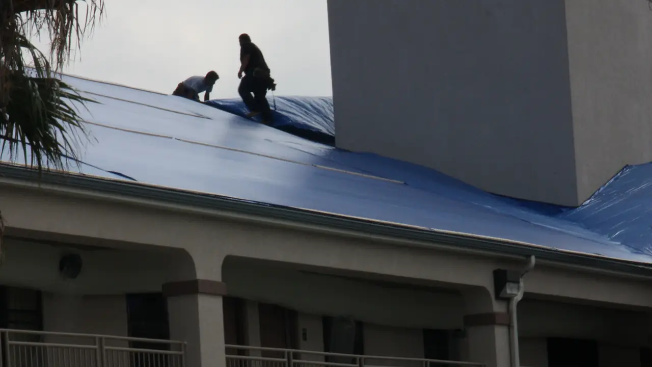 Tarp covering storm damage on a commercial roof