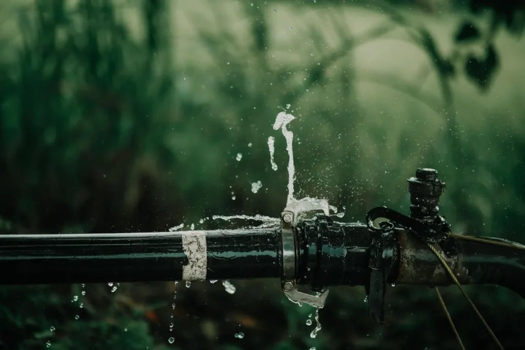 Pipe spraying water at a fitting, one of the leaks that causes the most damage